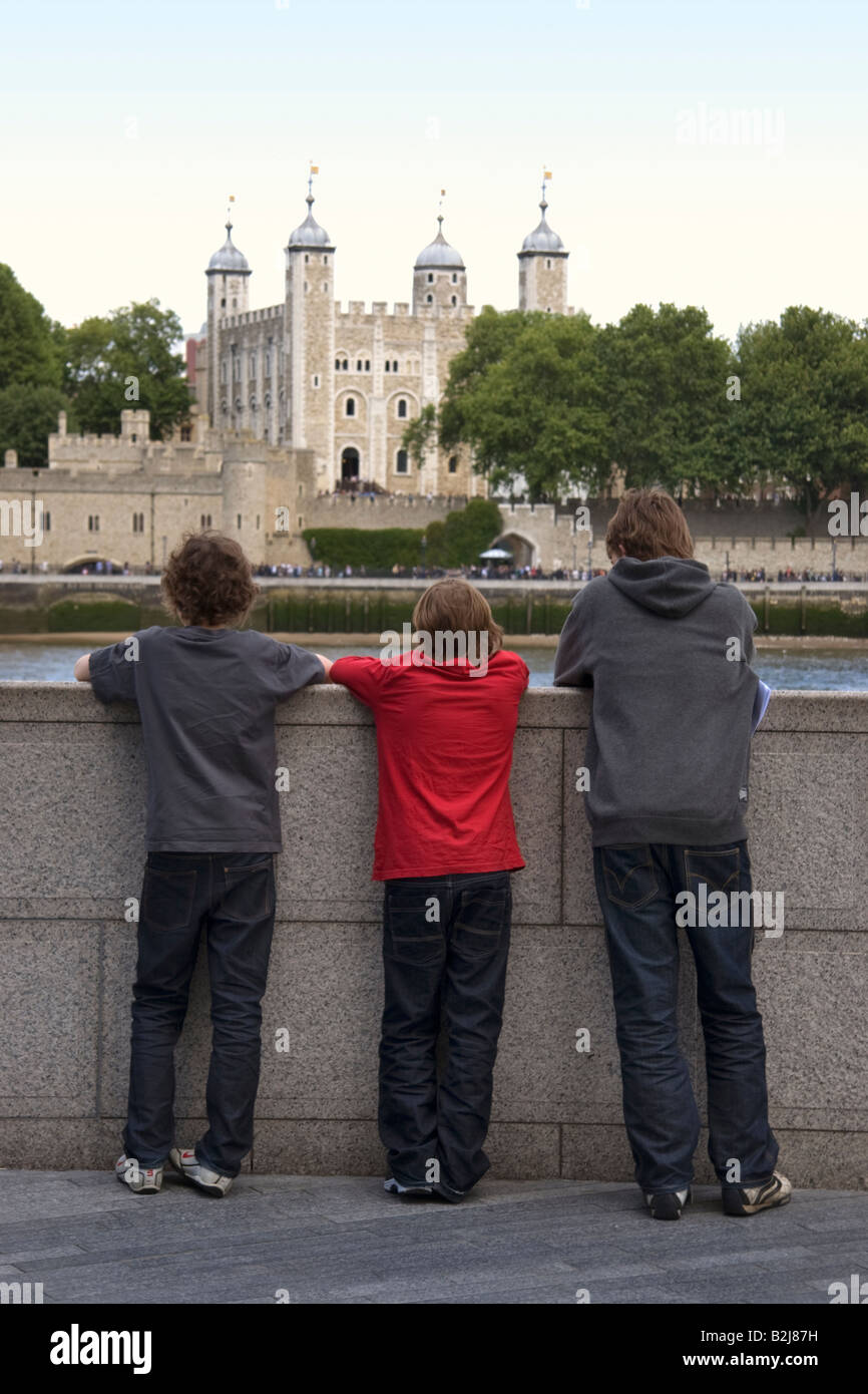 Three boys looking across the River Thames at the Tower of London Stock Photo
