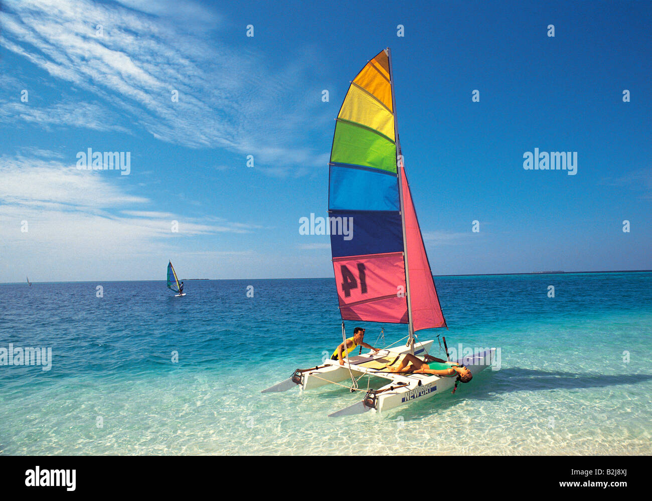 Maldives. Young couple sailing hoby cat catamaran in clear blue sea Stock Photo Alamy