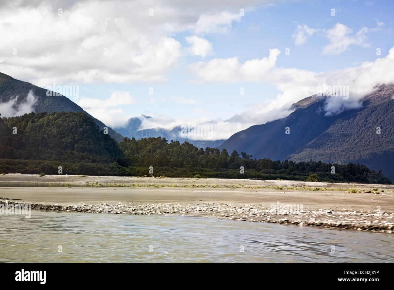 SOUTHERN ALPS BEYOND HAAST RIVER SOUTH ISLAND NEW ZEALAND Stock Photo