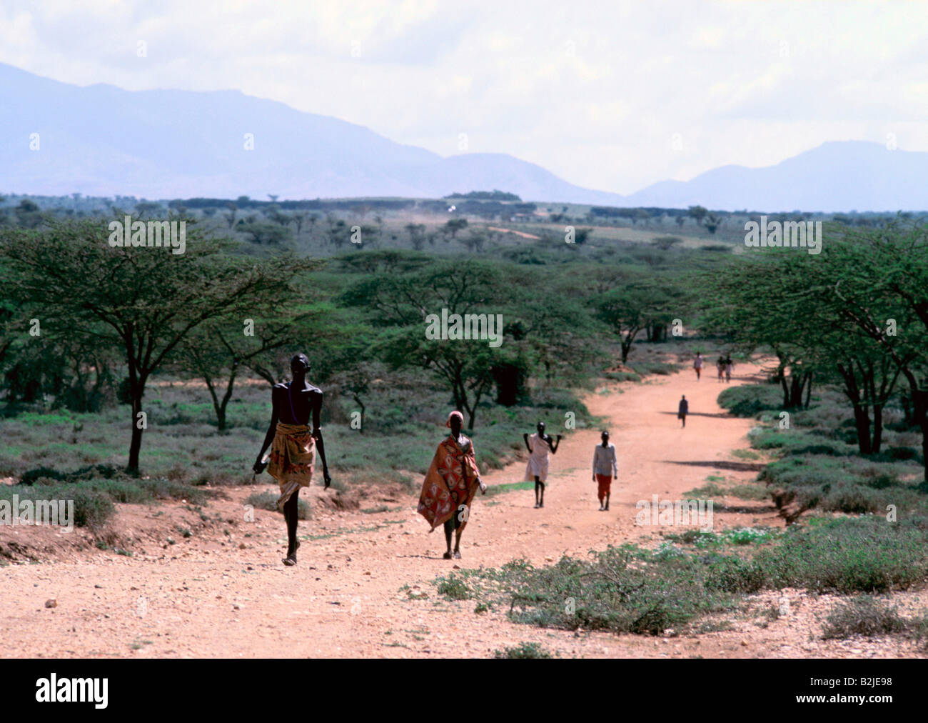 samburu people walking across kenyan landscape Stock Photo