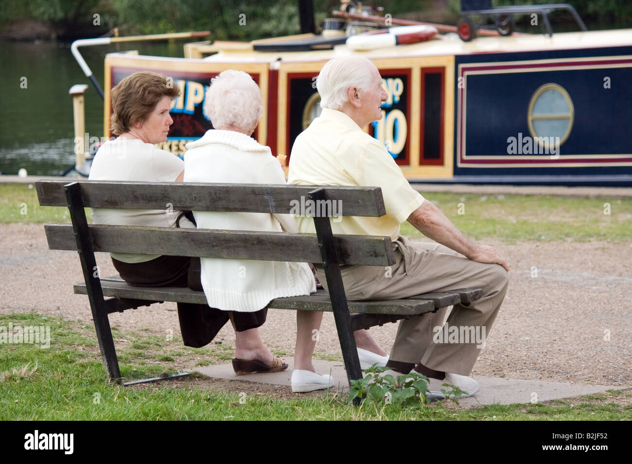 Three old age pensioners sitting on a bench Stock Photo - Alamy