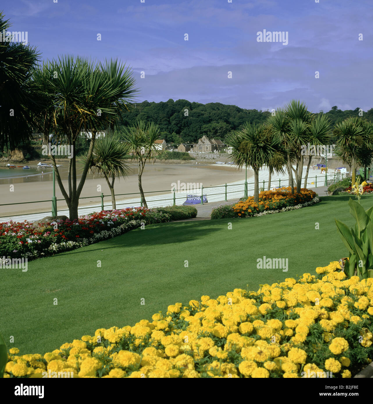 Seafront promenade Beach sand Railings Flower beds planted with yellow