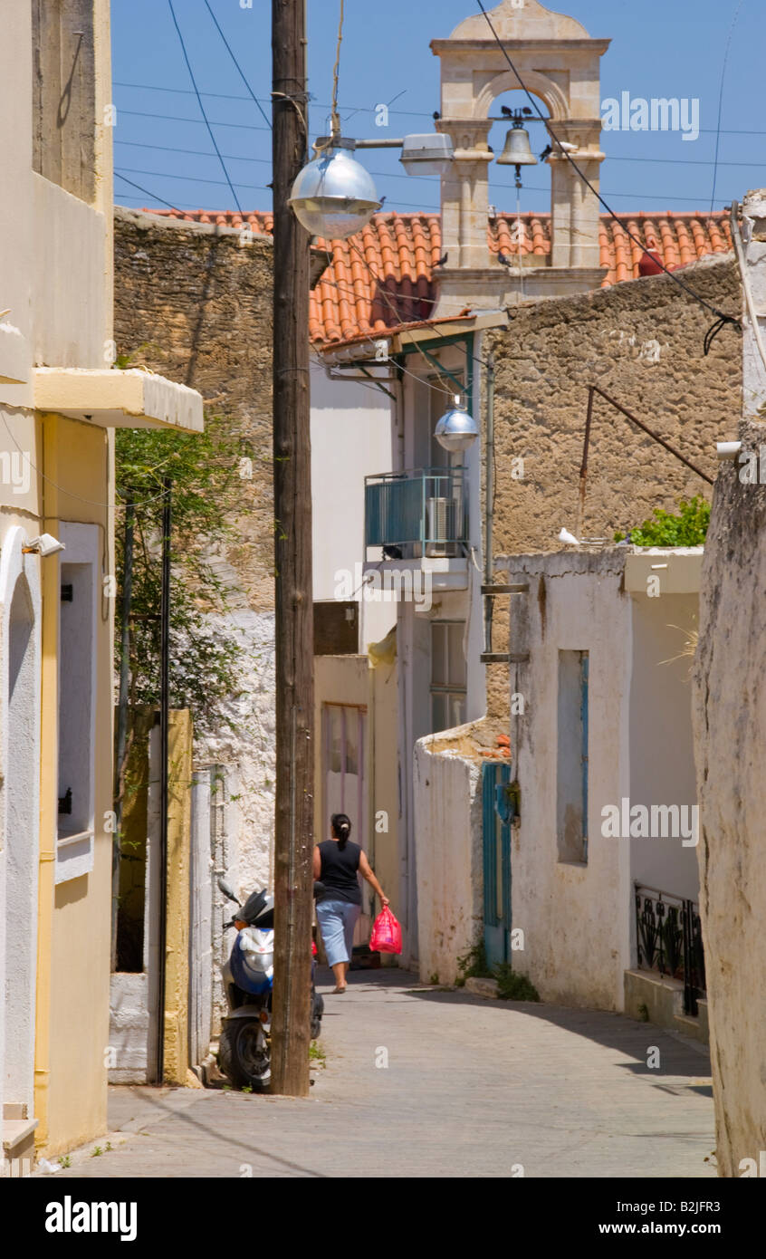 View down narrow village street in Malia Old Town on the Greek Mediterranean island of Crete GR EU Stock Photo