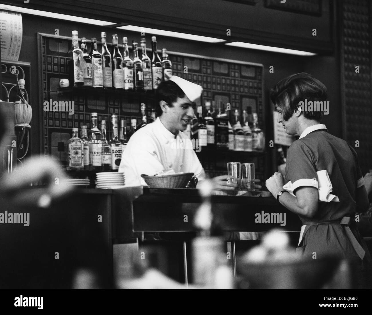 gastronomy, cafe, bartender and waitress in Italian cafe, Italy, bar, barkeeper, bottles, alcohol, alcoholic beverages, historic, historical, people, 20th century, Stock Photo