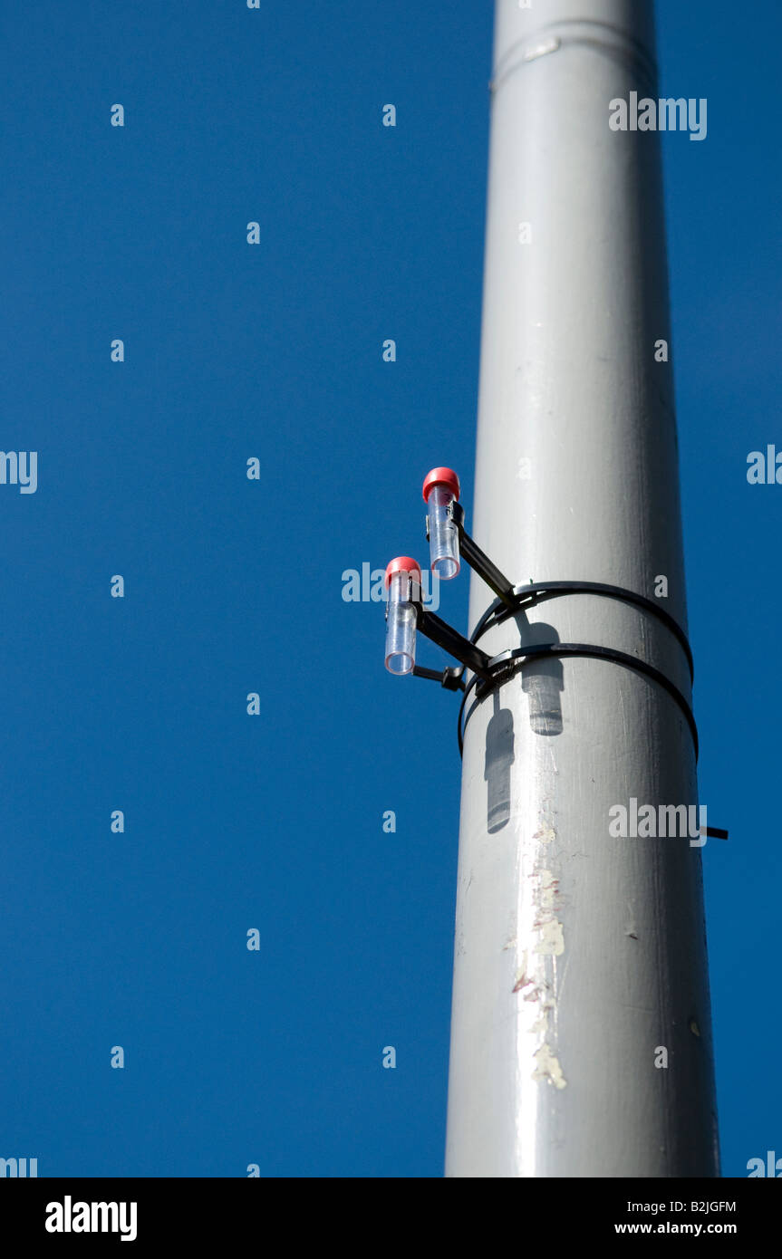 Diffusion tube used for the long term monitoring of air quality and pollution placed on a lamp post Stock Photo