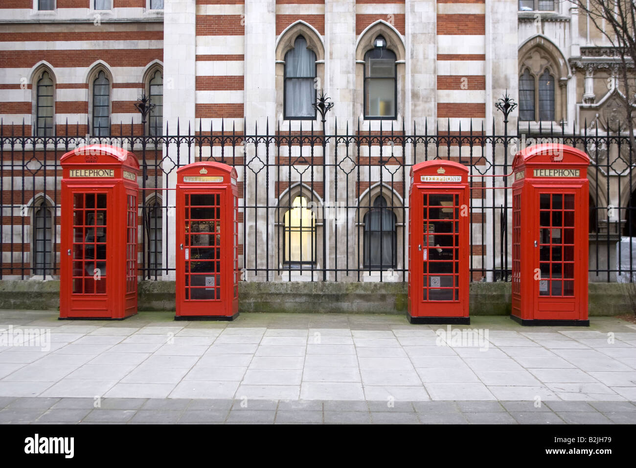 Four red telephone boxes in a row Stock Photo