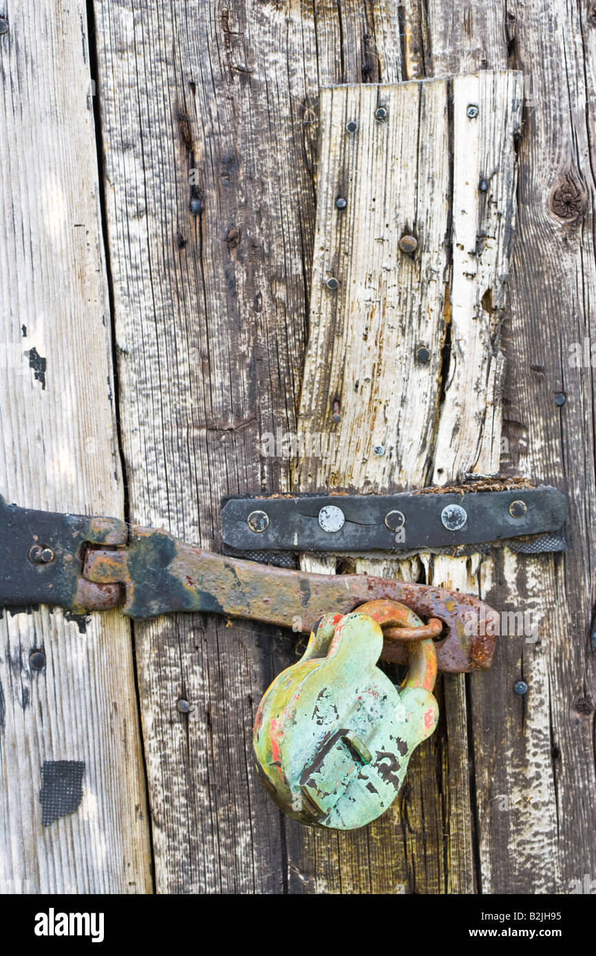 Locked door on one of the upturned boats used as a store by the