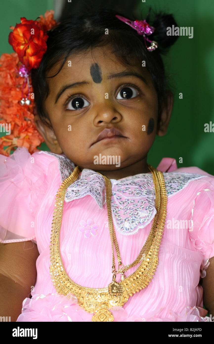 Portrait of a young Hindu girl with black spot makeup against the evil