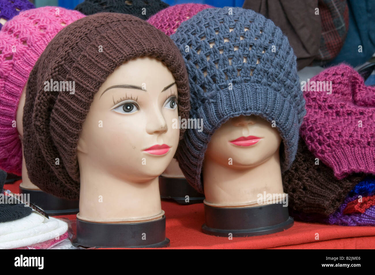 Pair of mannequins wearing woolly hats Stock Photo Alamy