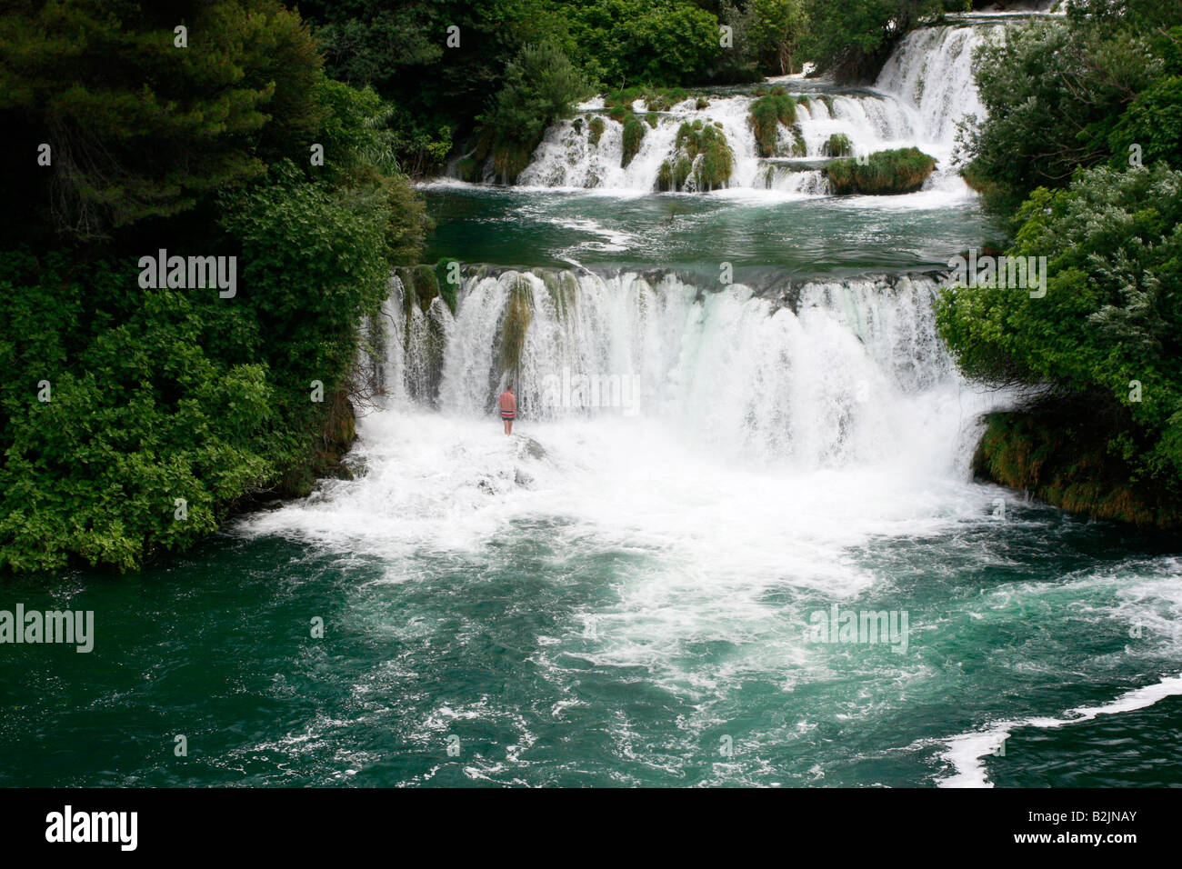 Croatian holidaymaker enjoying swimming in the spectacular waterfalls of the Krka National Park in Croatia Stock Photo