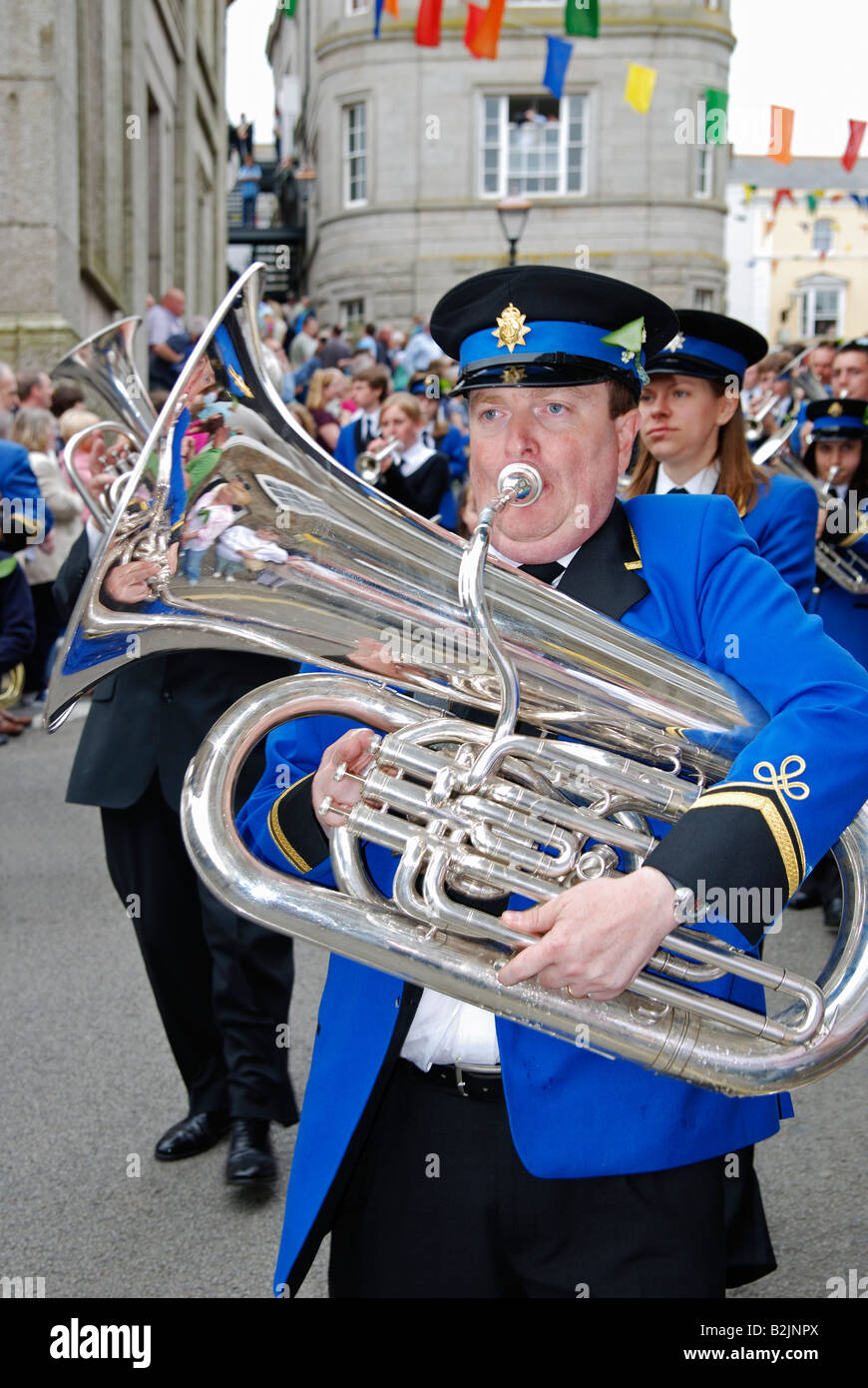a musician playing the trombone in a marching band at helston,cornwall,uk on flora day Stock Photo