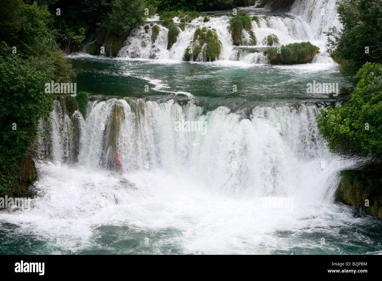 Croatian holidaymaker enjoying swimming in the spectacular waterfalls of the Krka National Park in Croatia Stock Photo