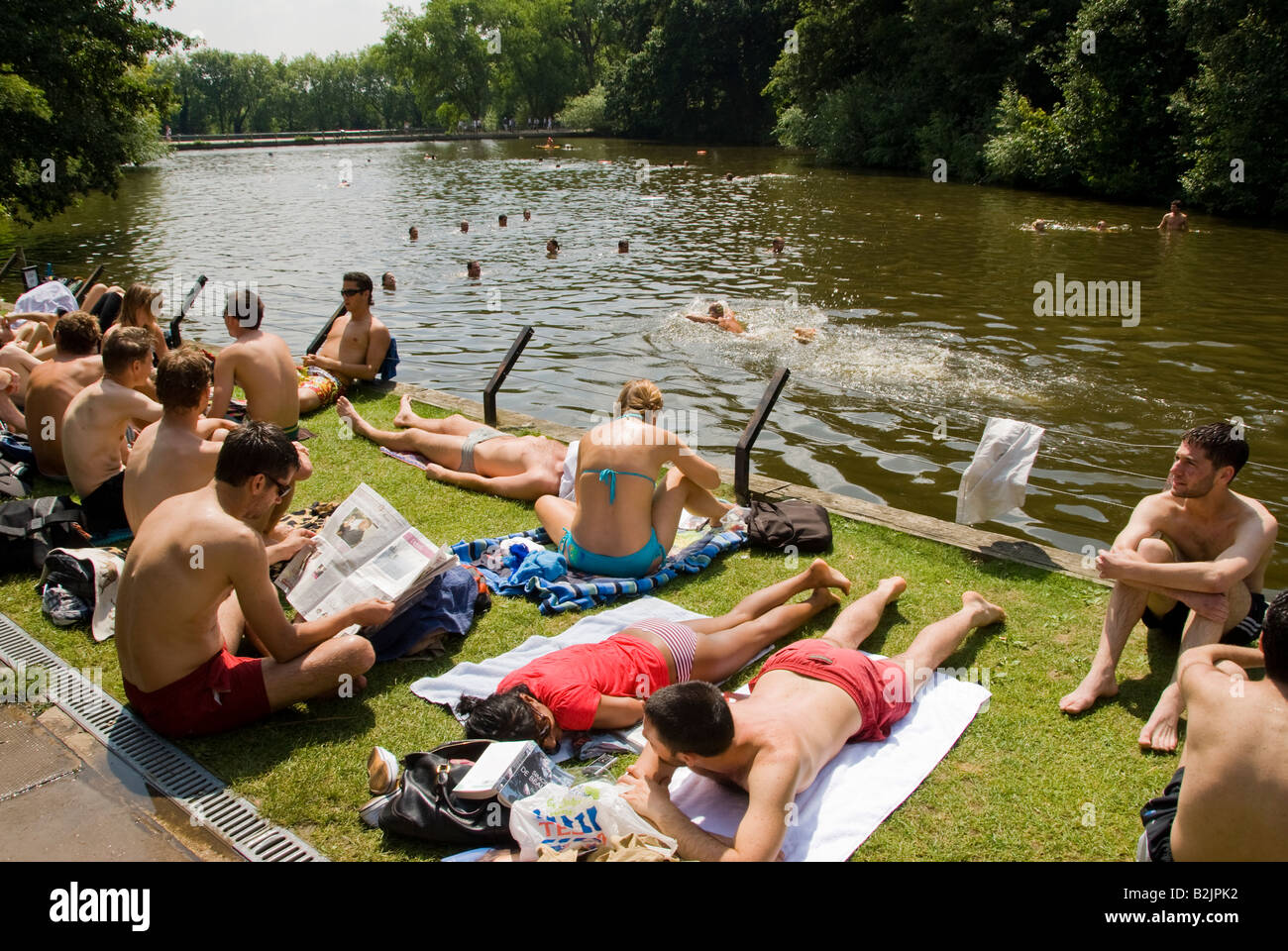 People relaxing at the Hampstead Heath mixed swimming pond in London Stock Photo