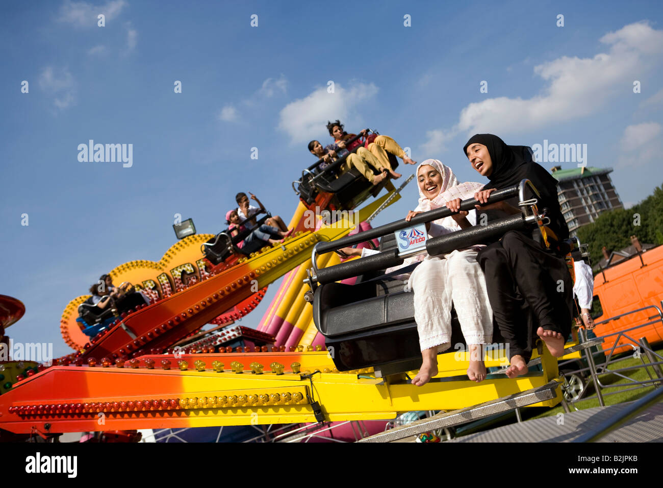 UK England Manchester Platt Fields Mega Mela hijab wearing moslem women on Mexican wave fairground ride Stock Photo