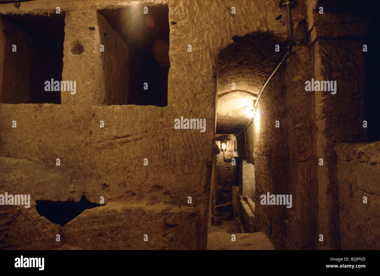 Catacombs of Kom Ash-Shuqqafa Interior Chambers narrow corridors Lit by lamp ALEXANDRIA EGYPT Stock Photo