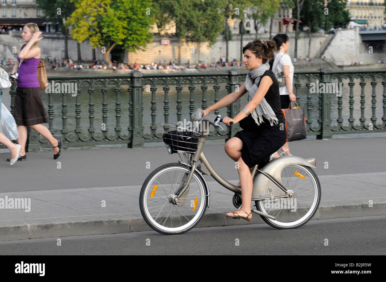 A French girl cycling on a rental 'Velib' bicycle in central Paris, France Stock Photo
