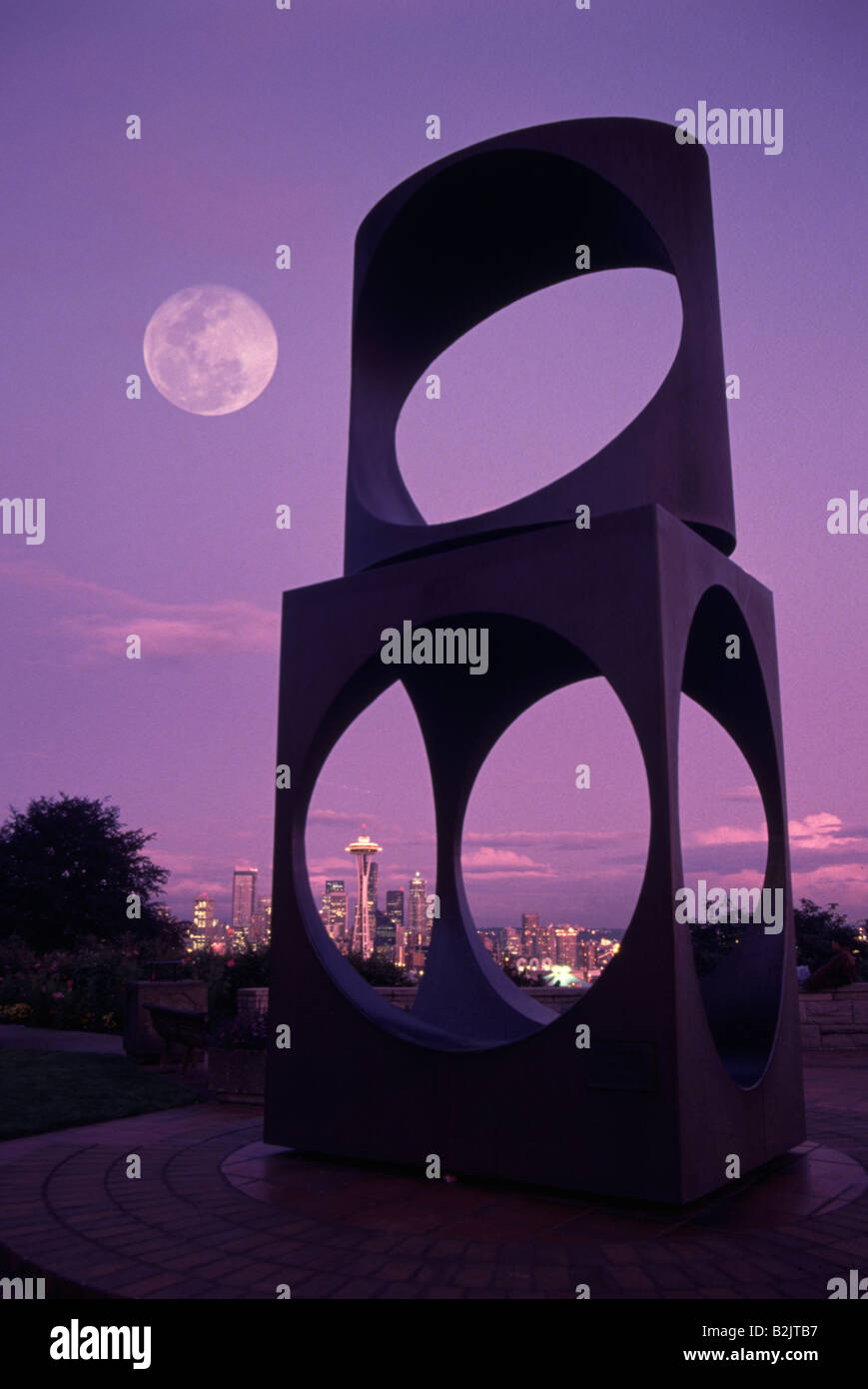 Seattle with the Space Needle and Full Moon Rising from Kerry Park through a large sculpture. Stock Photo