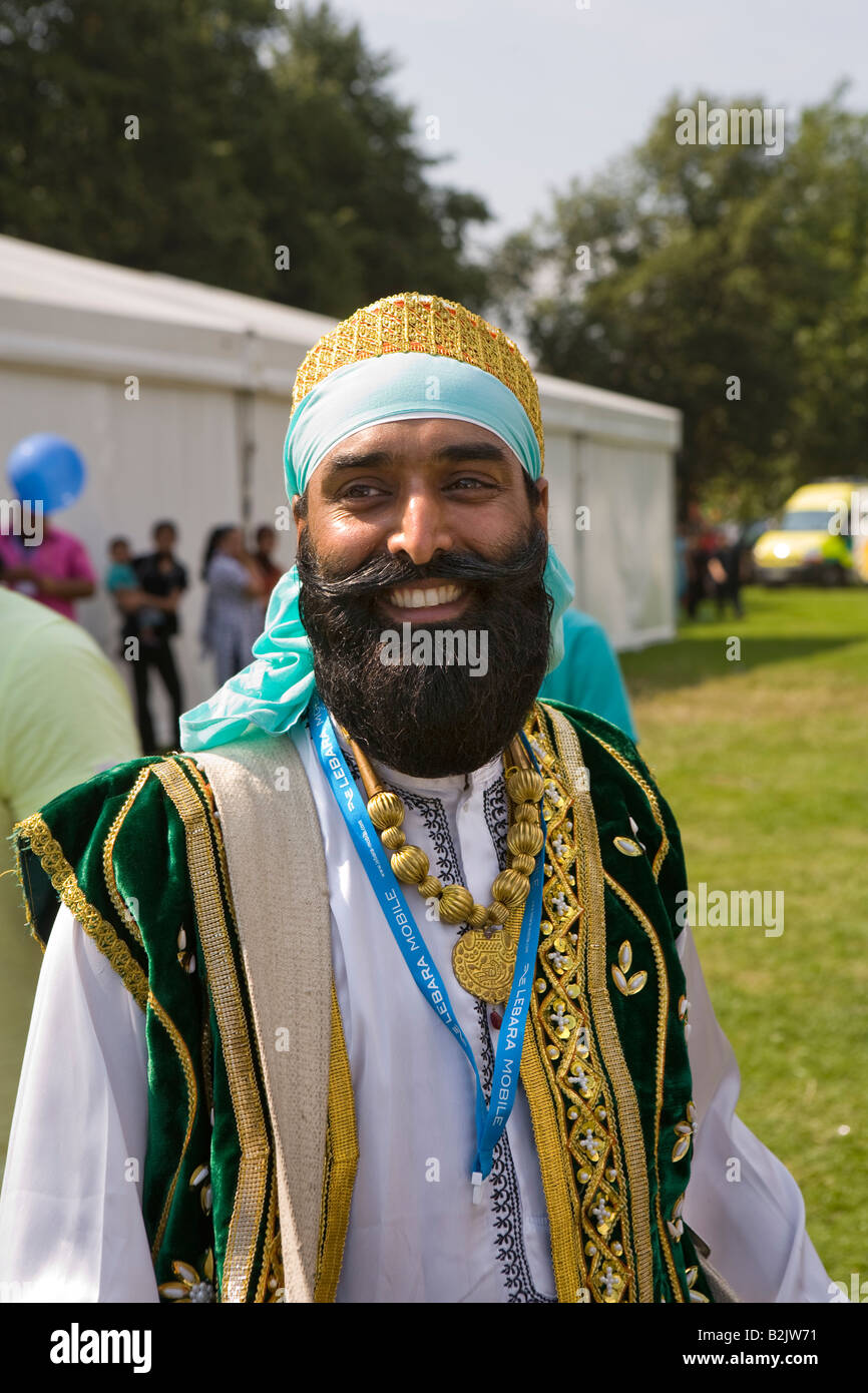 UK England Manchester Platt Fields Mega Mela face of bearded Sikh Bangra music drummer Stock Photo