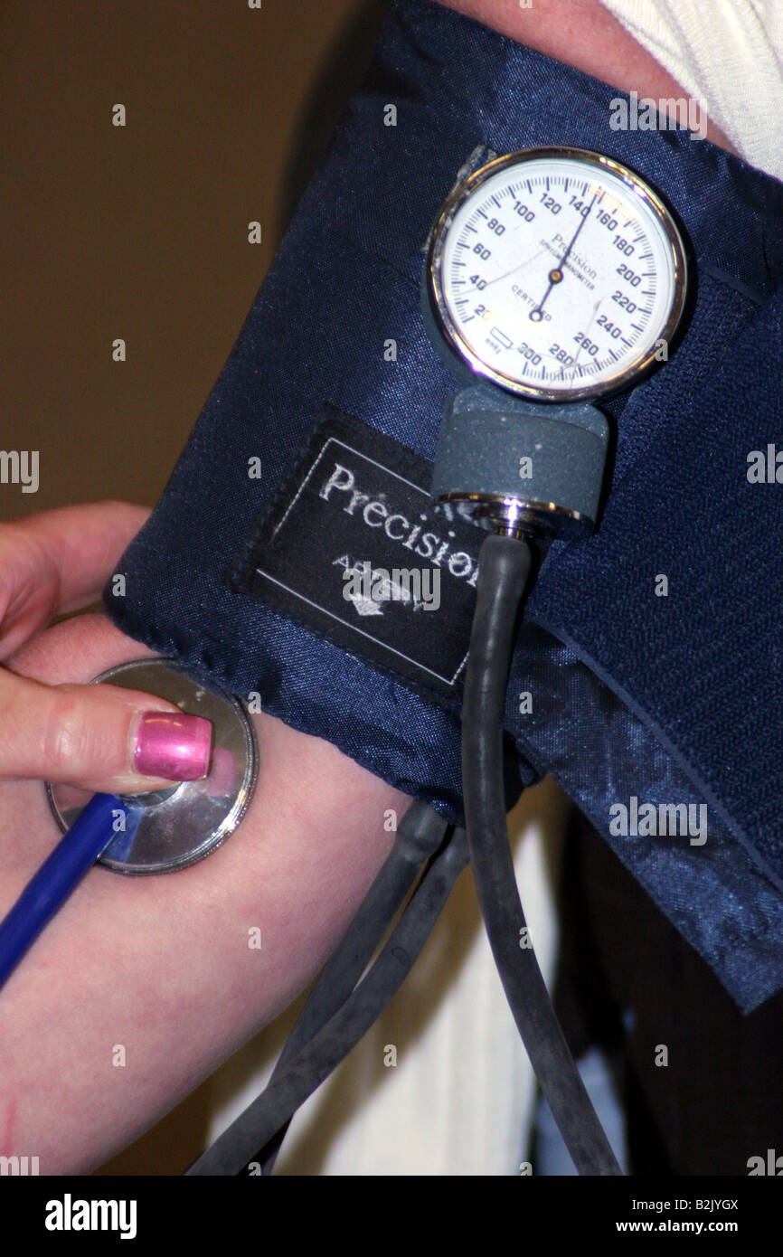 An EMT taking the blood pressure of a female patient Stock Photo