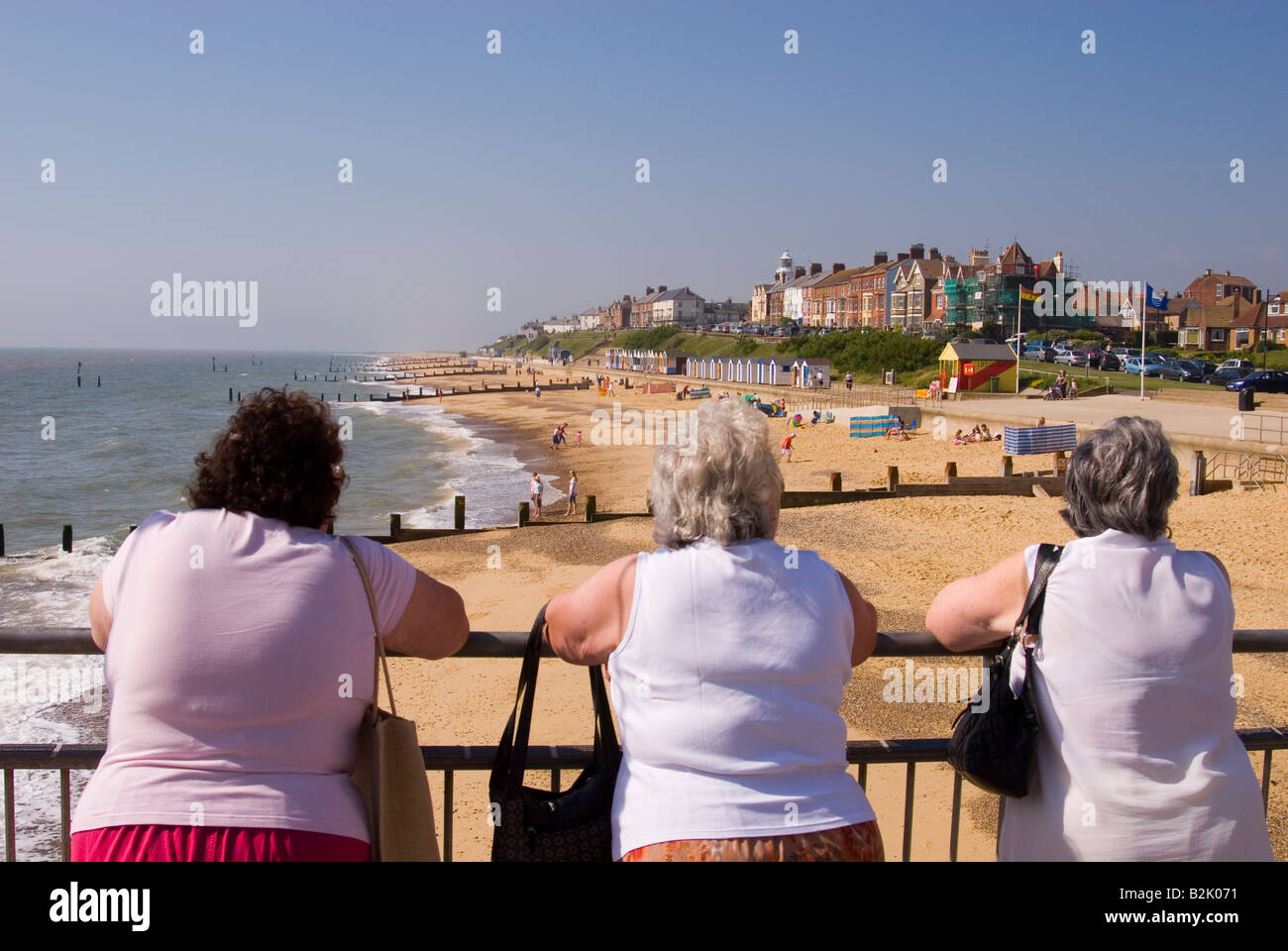 People On Southwold Pier Look Out Over Beach On A Hot Summers Day in the uk Stock Photo