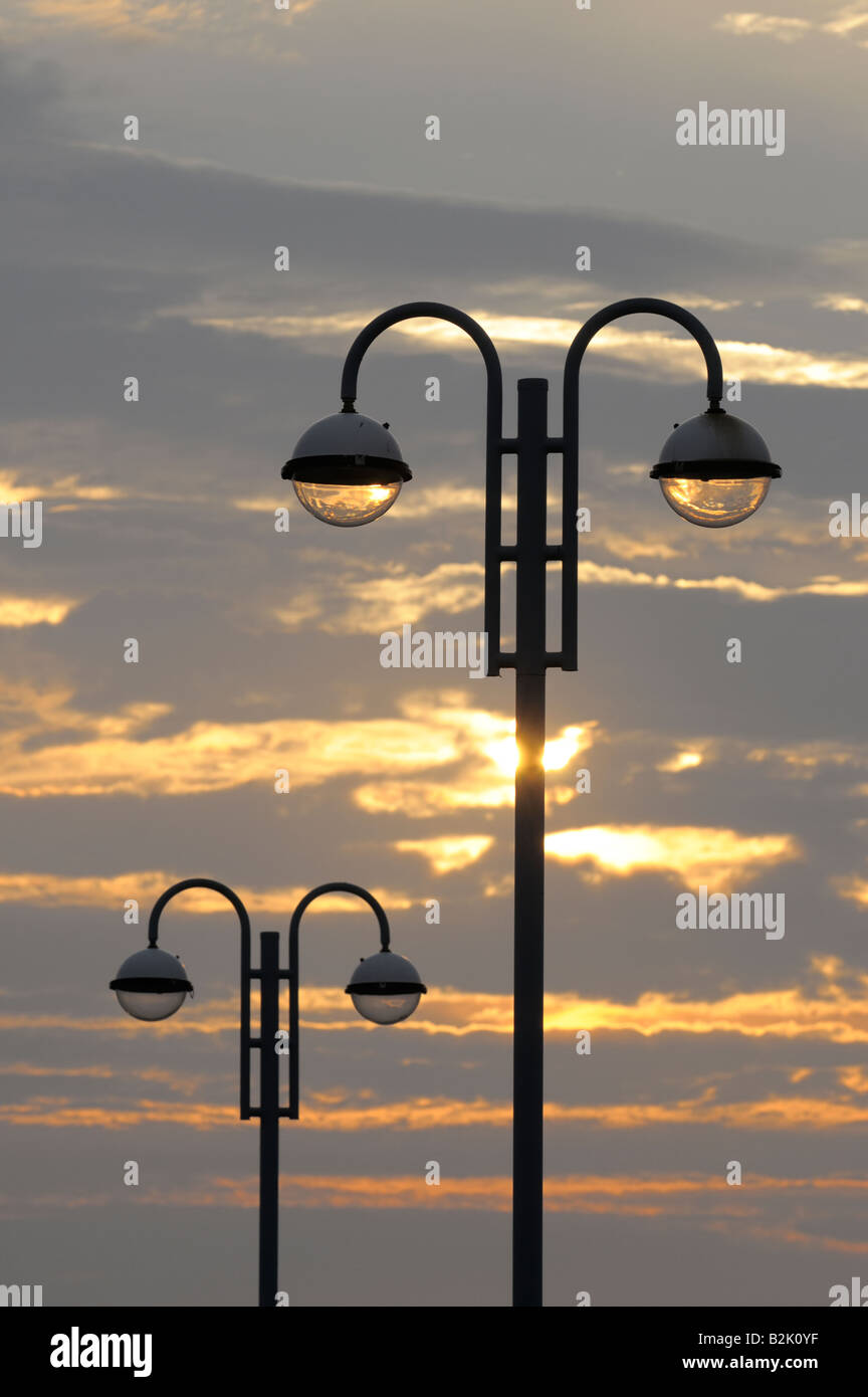 Street lamps on Morecambe promenade at sunset Stock Photo