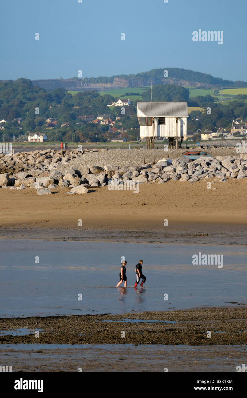 Two young people paddling on Morecambe beach Stock Photo