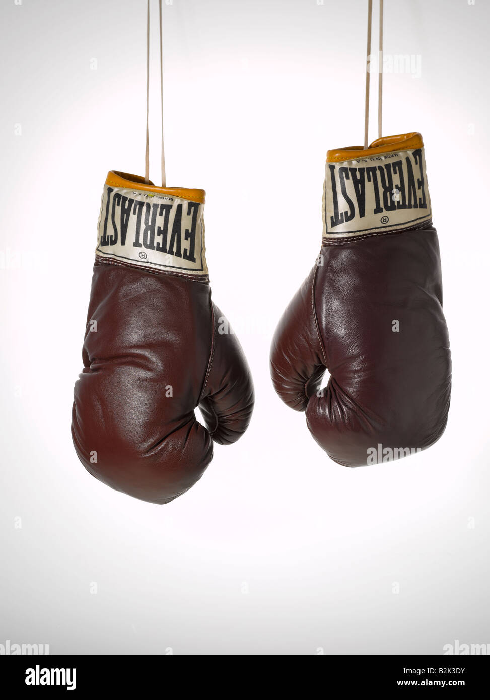 pair of brown vintage brown leather Everlast boxing gloves hanging with  strings Stock Photo - Alamy