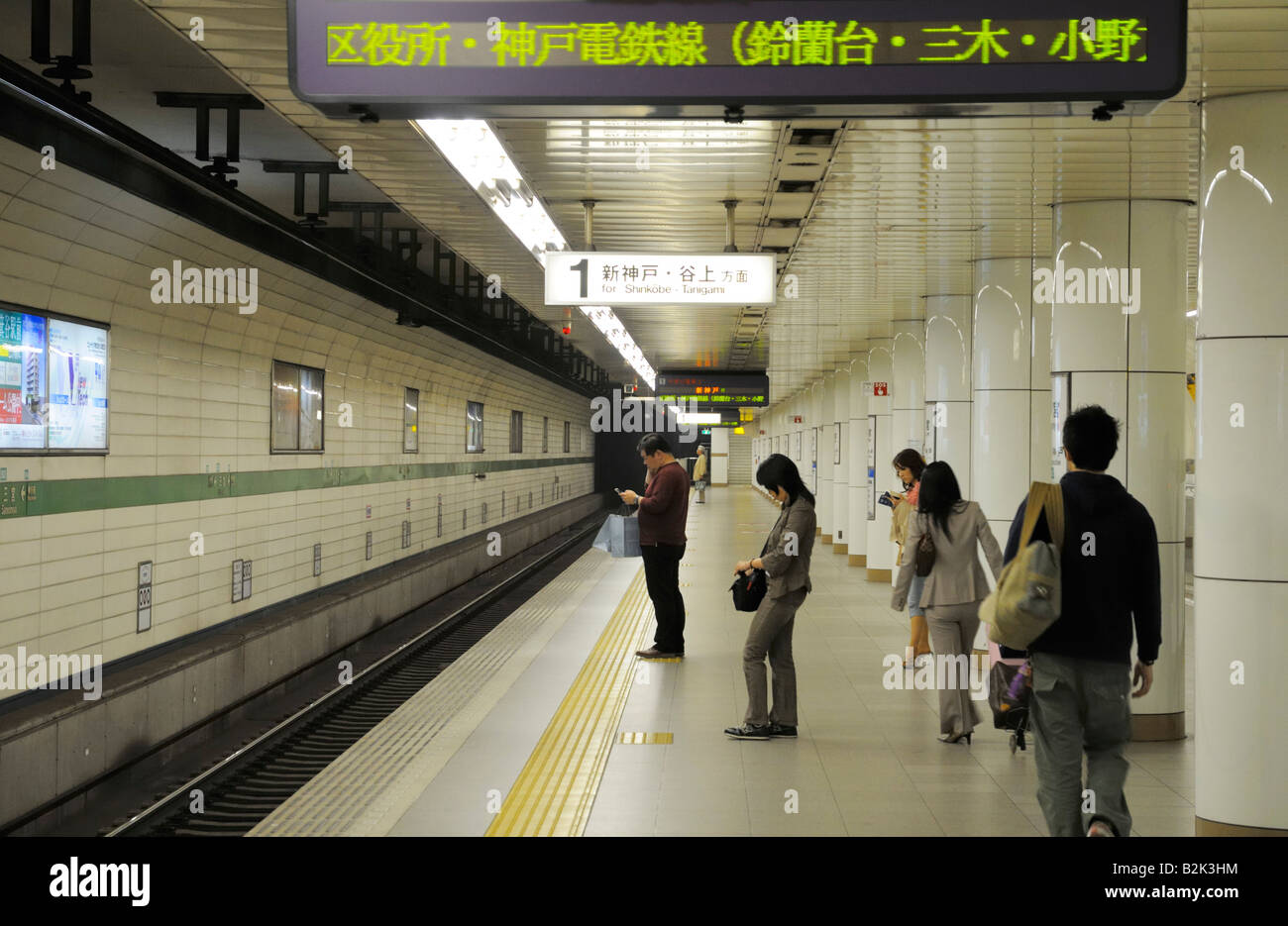 Passengers waiting in a subway station, Kobe JP Stock Photo