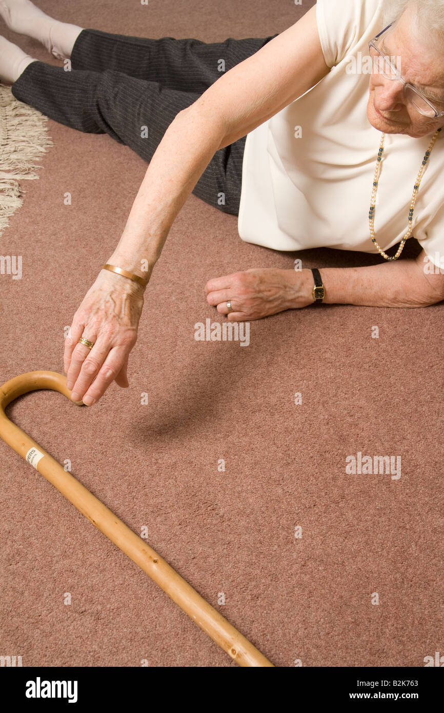 Old woman fallen on the floor, UK. Stock Photo