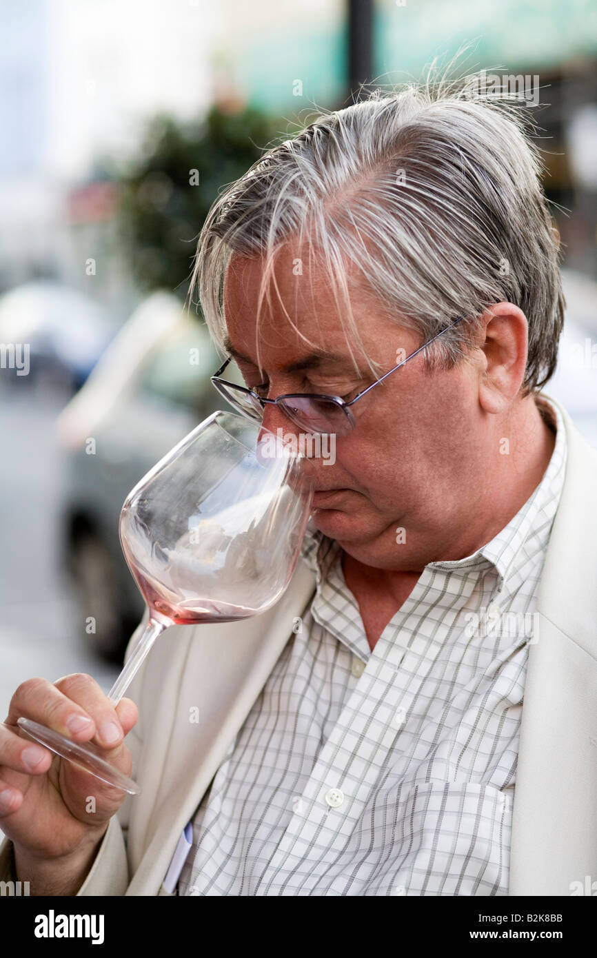 Senior adult man smelling wine Stock Photo - Alamy