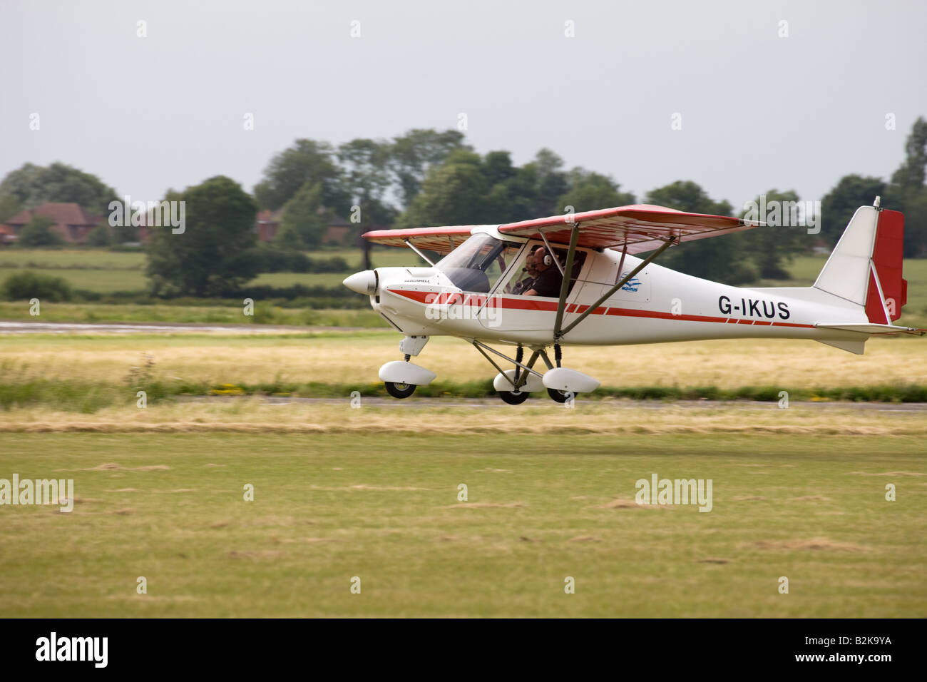 Ikarus C42 FB UK G-IKUS landing & about to touchdown at Wickenby Airfield Stock Photo