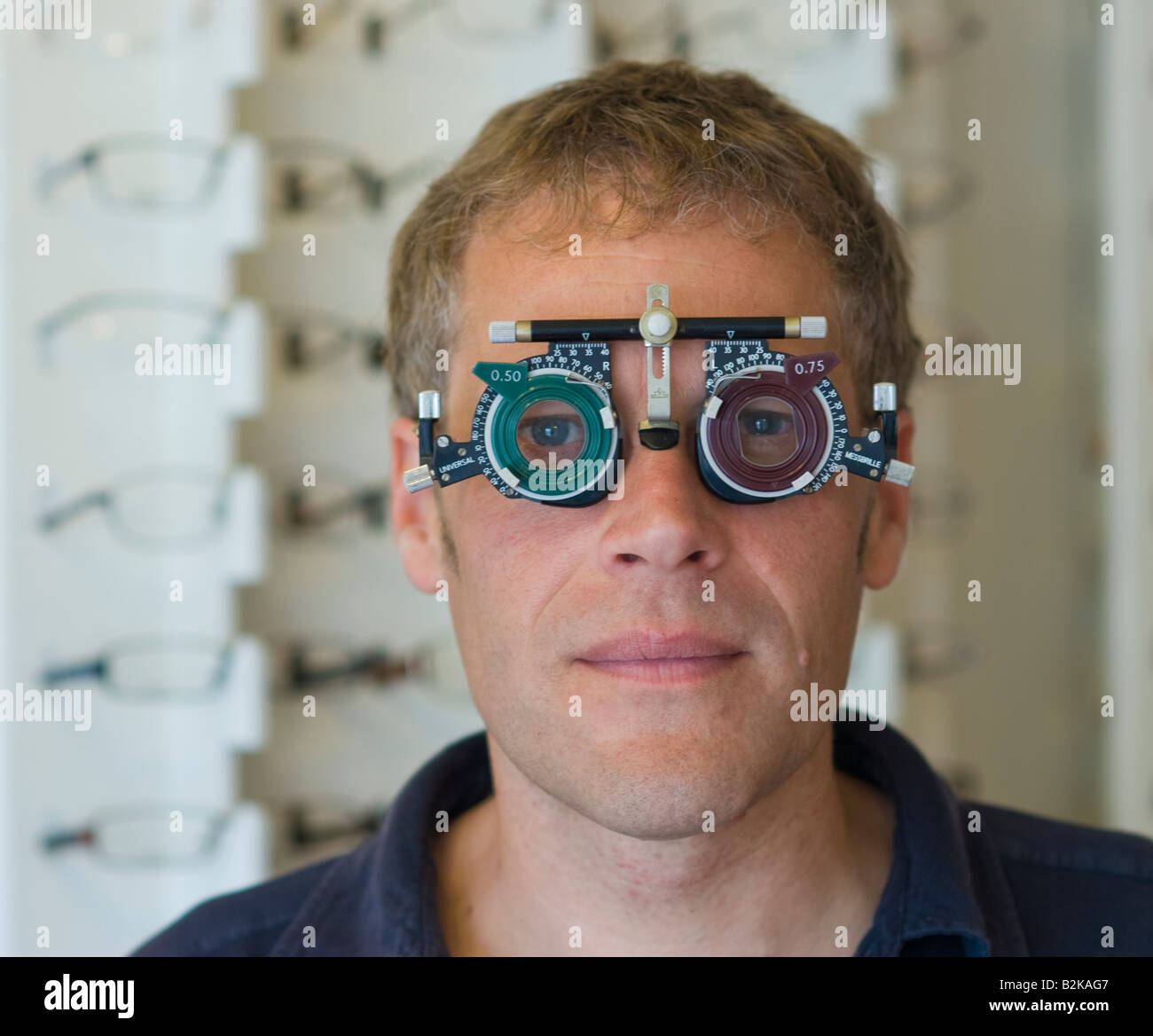 A man having his eye sight tested at an opticians in Britain Stock