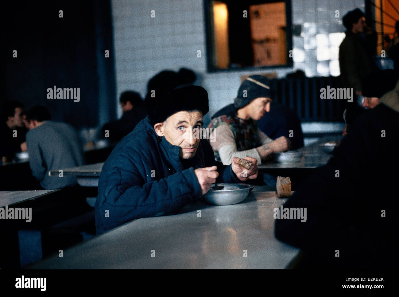 prisoners eating meal of bread and soup in a siberian prison canteen