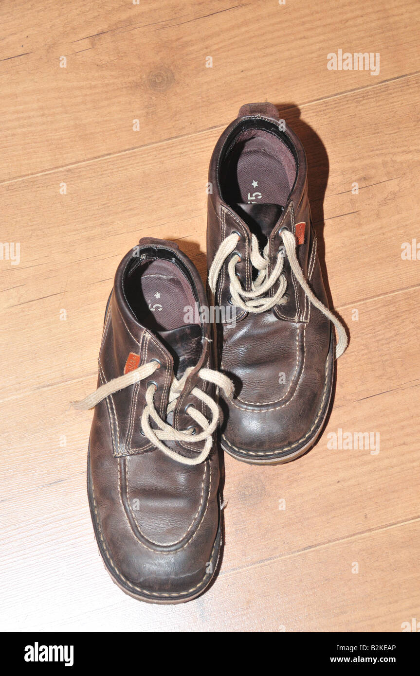 Pair of brown leather boots on a laminate wooden floor Stock Photo Alamy