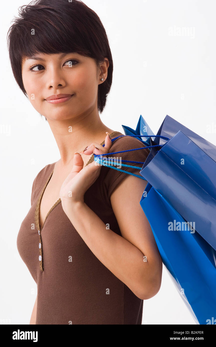 Close-up of a young woman carrying shopping bags Stock Photo - Alamy