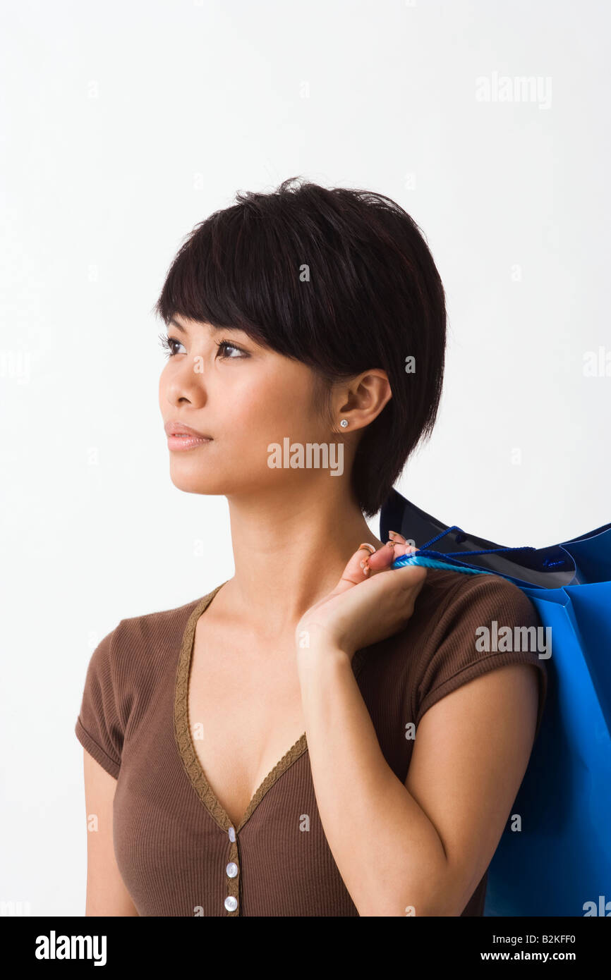 Close-up of a young woman carrying shopping bags Stock Photo - Alamy