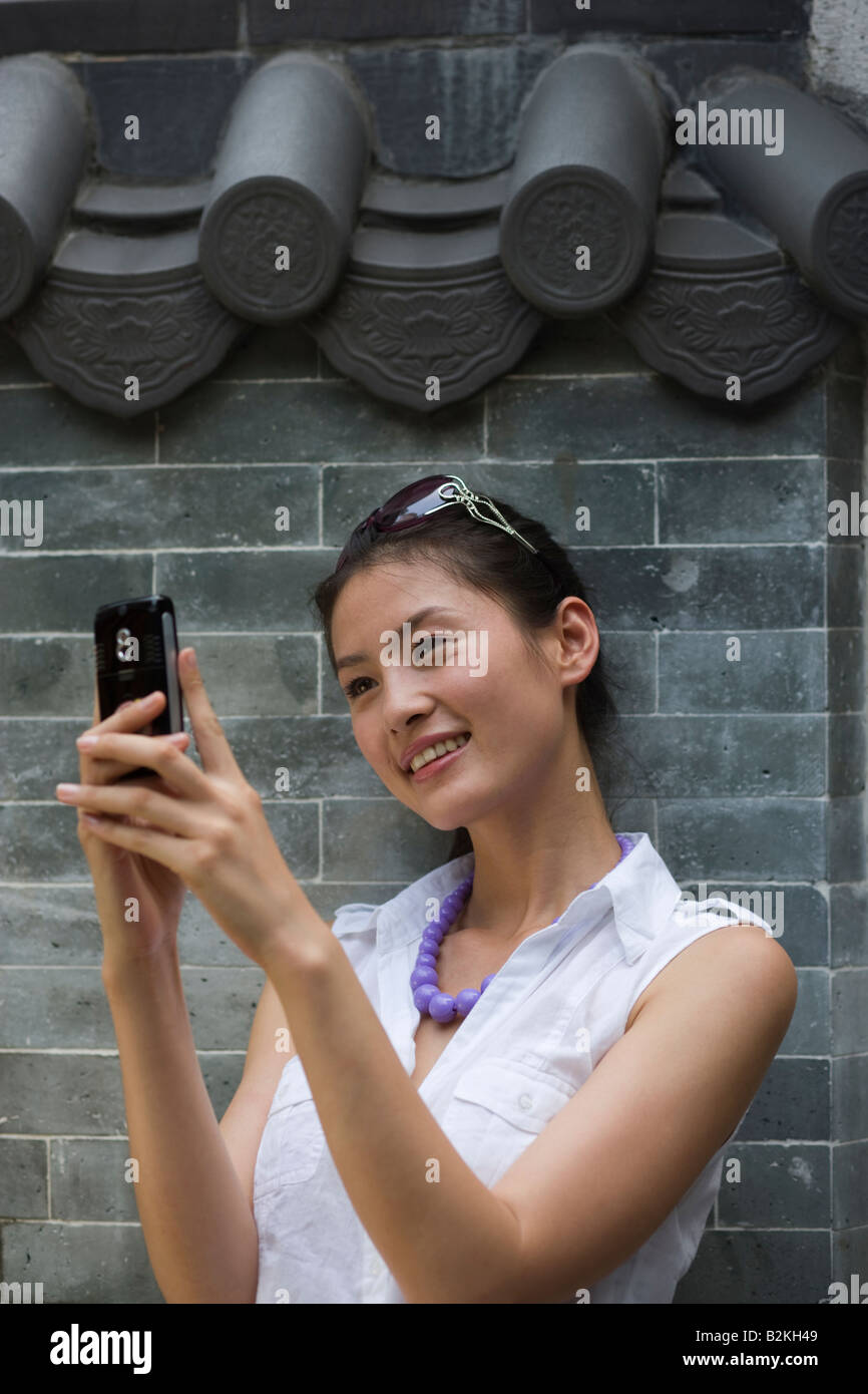 Young woman text messaging and smiling Stock Photo - Alamy