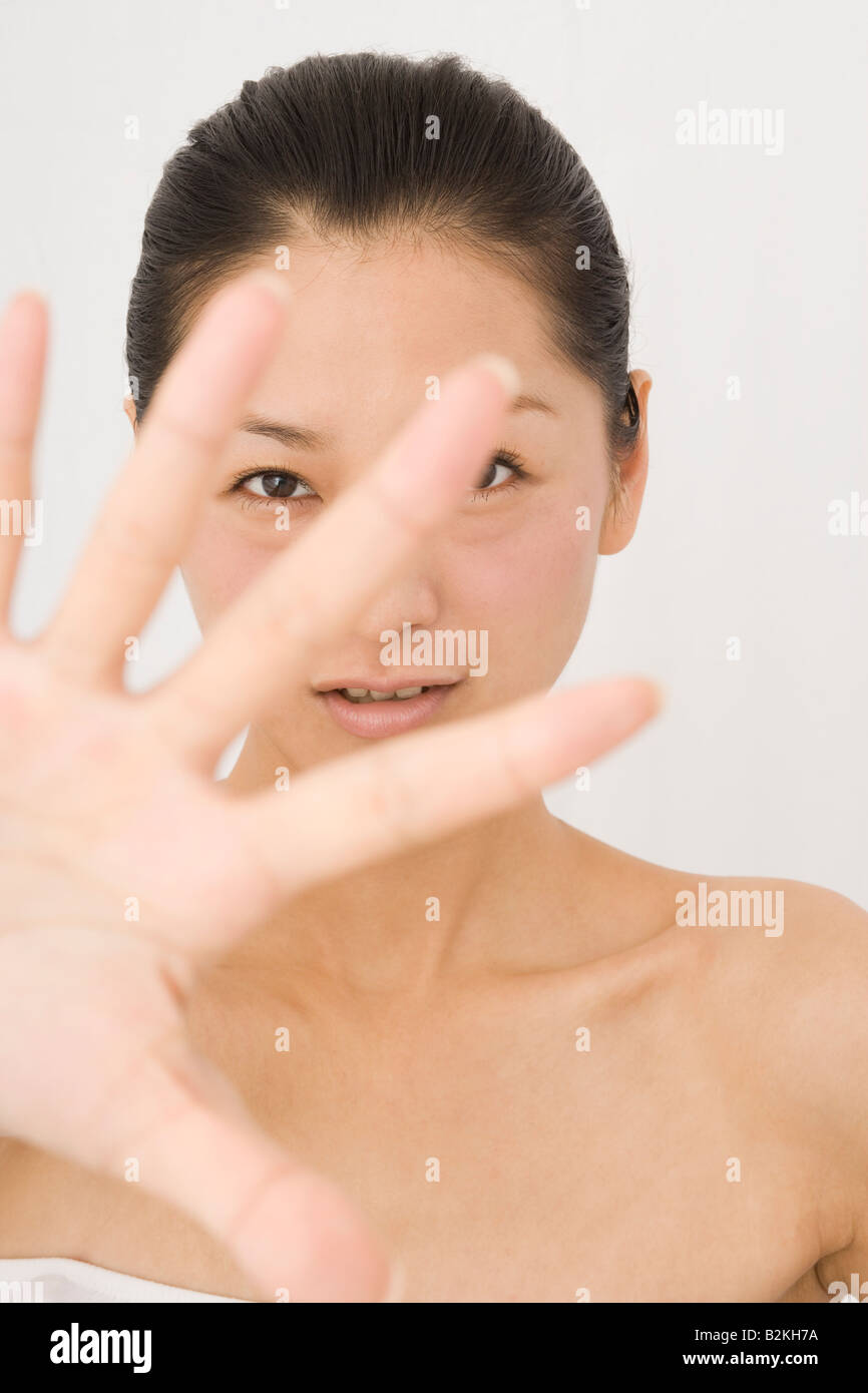 Portrait of a young woman showing a stop sign Stock Photo - Alamy