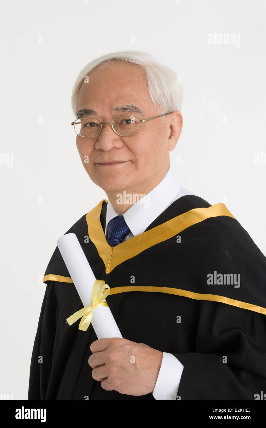 Portrait of a senior male graduate holding a diploma and smiling Stock ...
