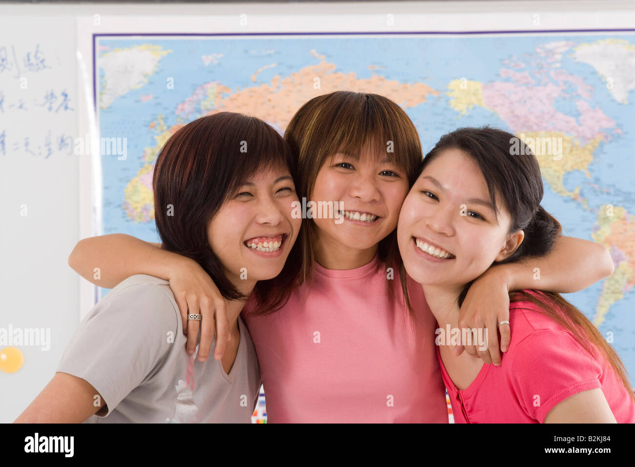 Portrait of three young women looking cheerful Stock Photo - Alamy