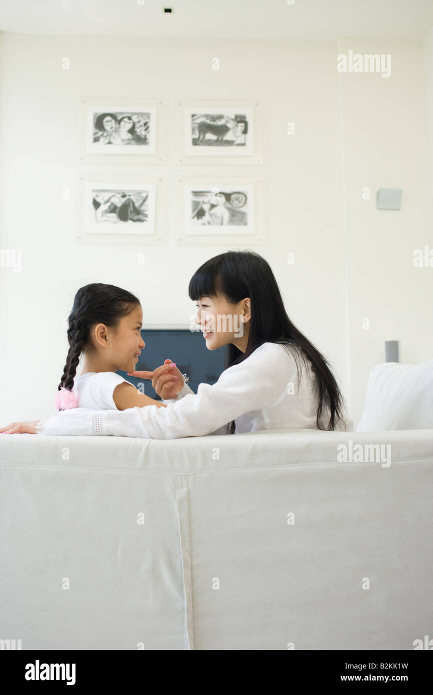 Woman touching her daughter's chin Stock Photo