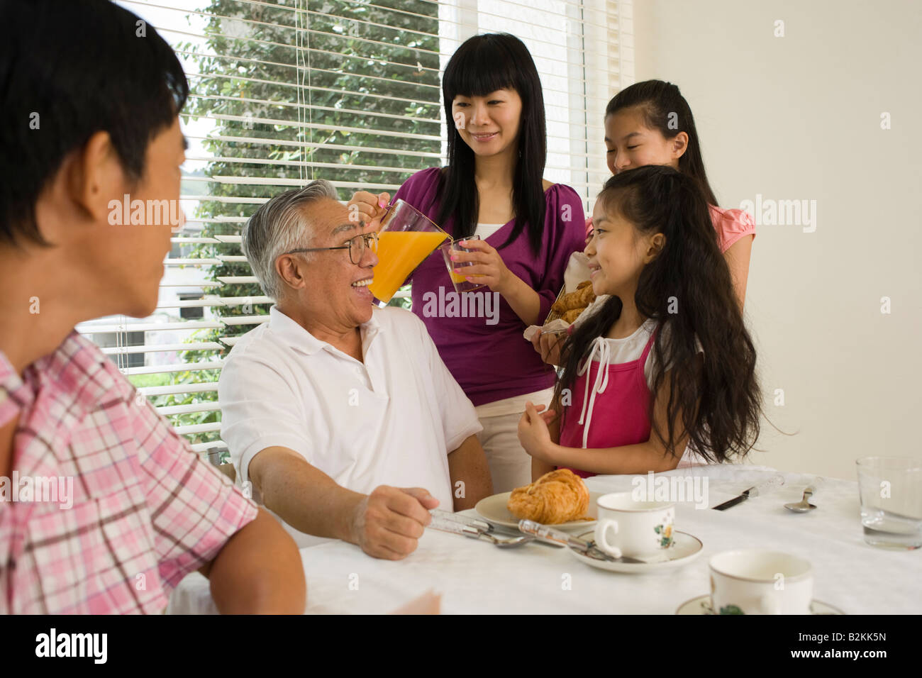 Family at a breakfast table Stock Photo - Alamy