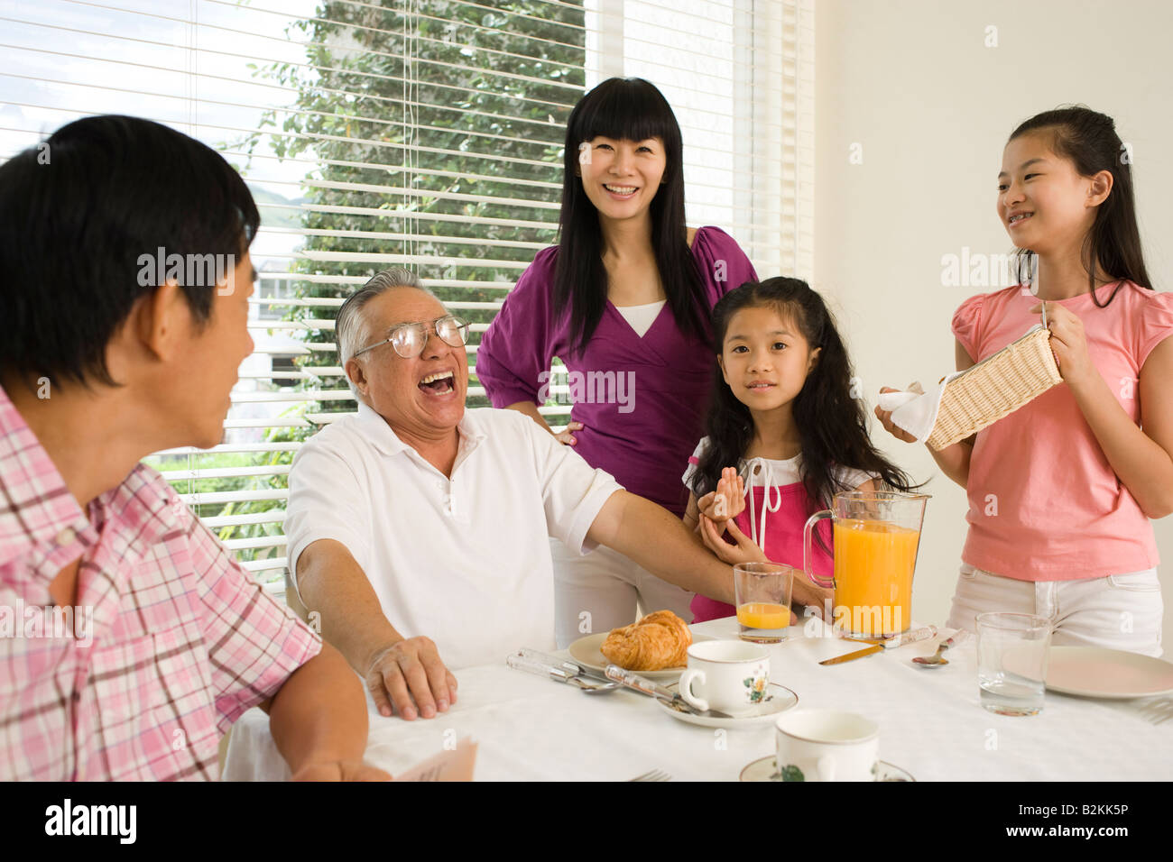 Family at a breakfast table Stock Photo - Alamy