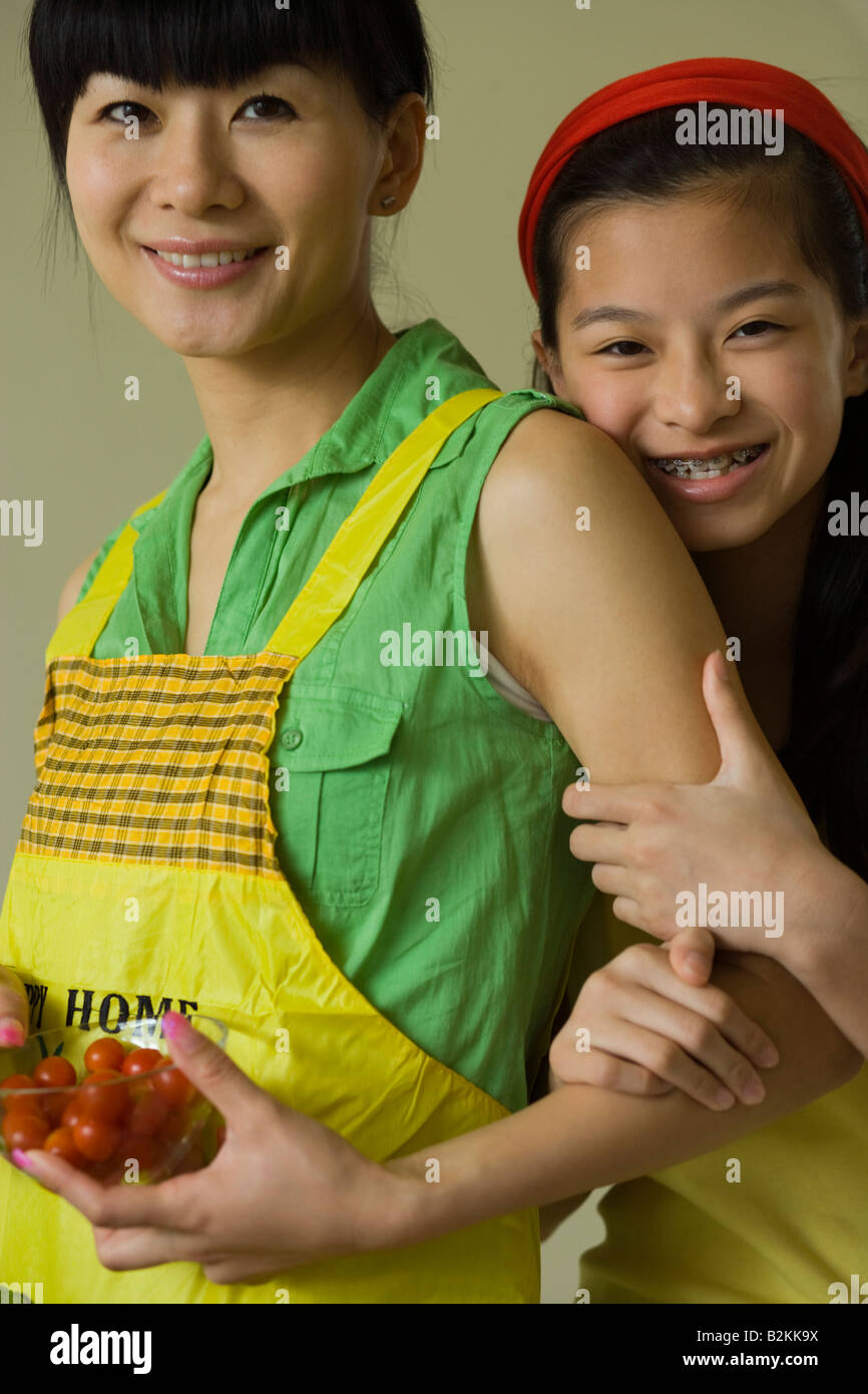 Portrait of a mid adult woman holding cherry tomatoes and smiling with ...