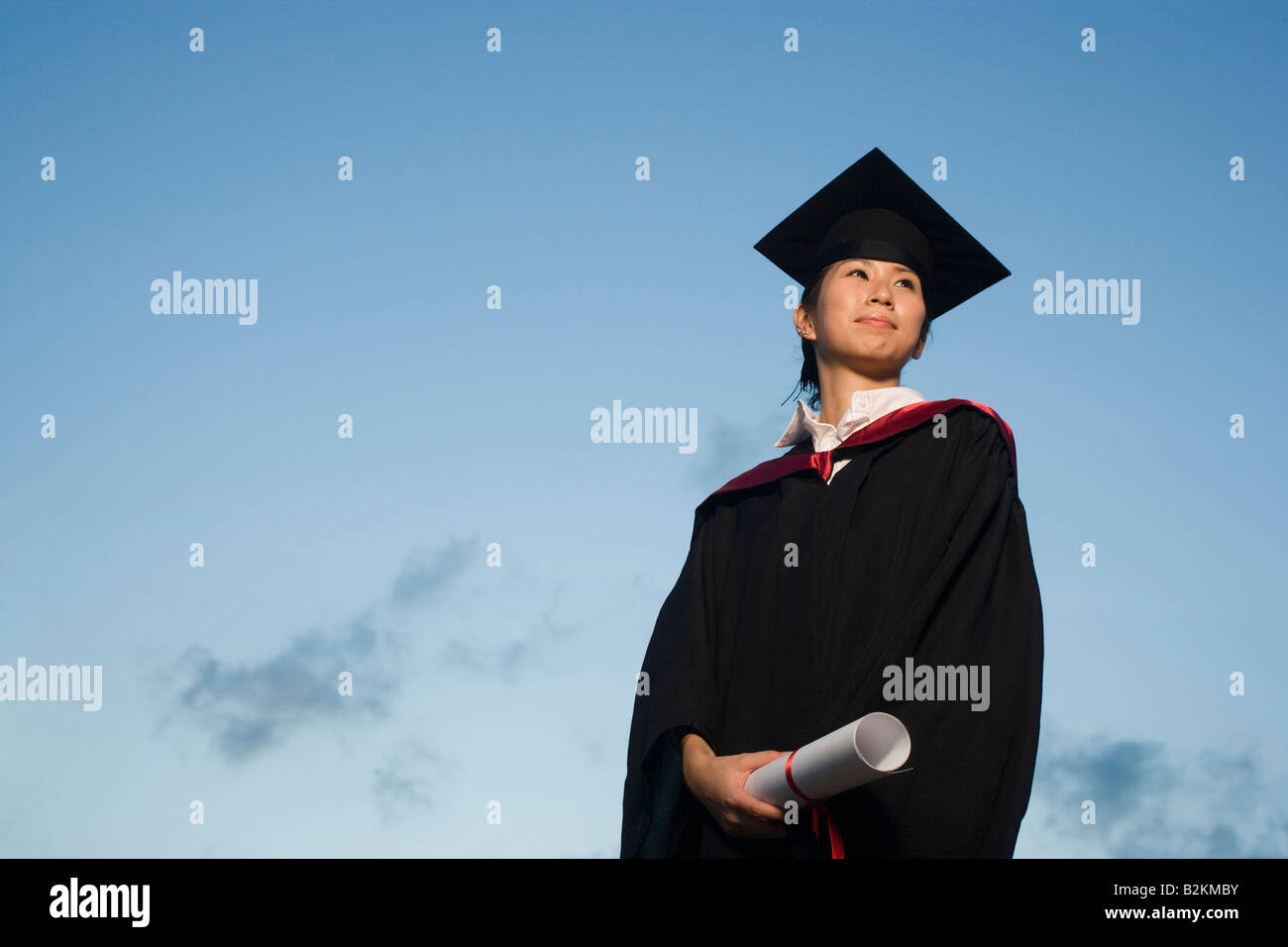 Low angle view of a young female graduate holding a diploma Stock Photo ...