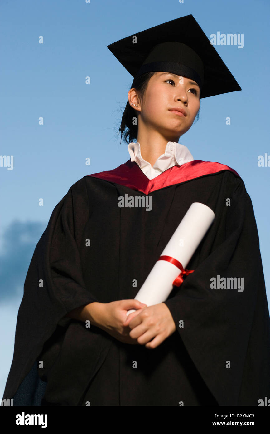 Low angle view of a young female graduate holding a diploma Stock Photo ...