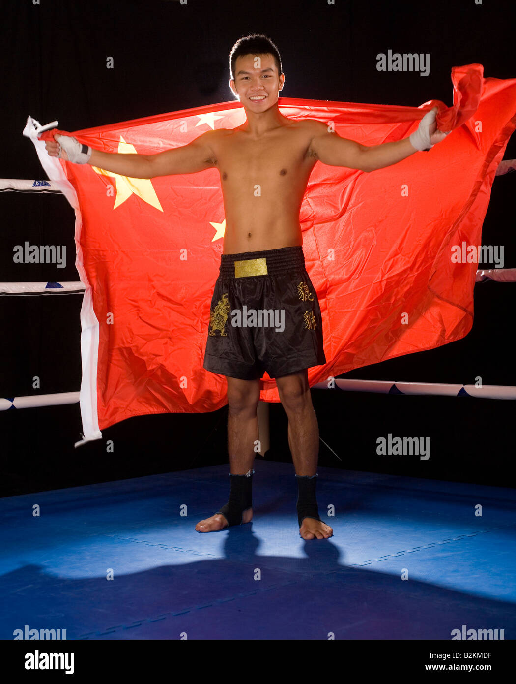 Young man holding a Chinese flag in a boxing ring Stock Photo