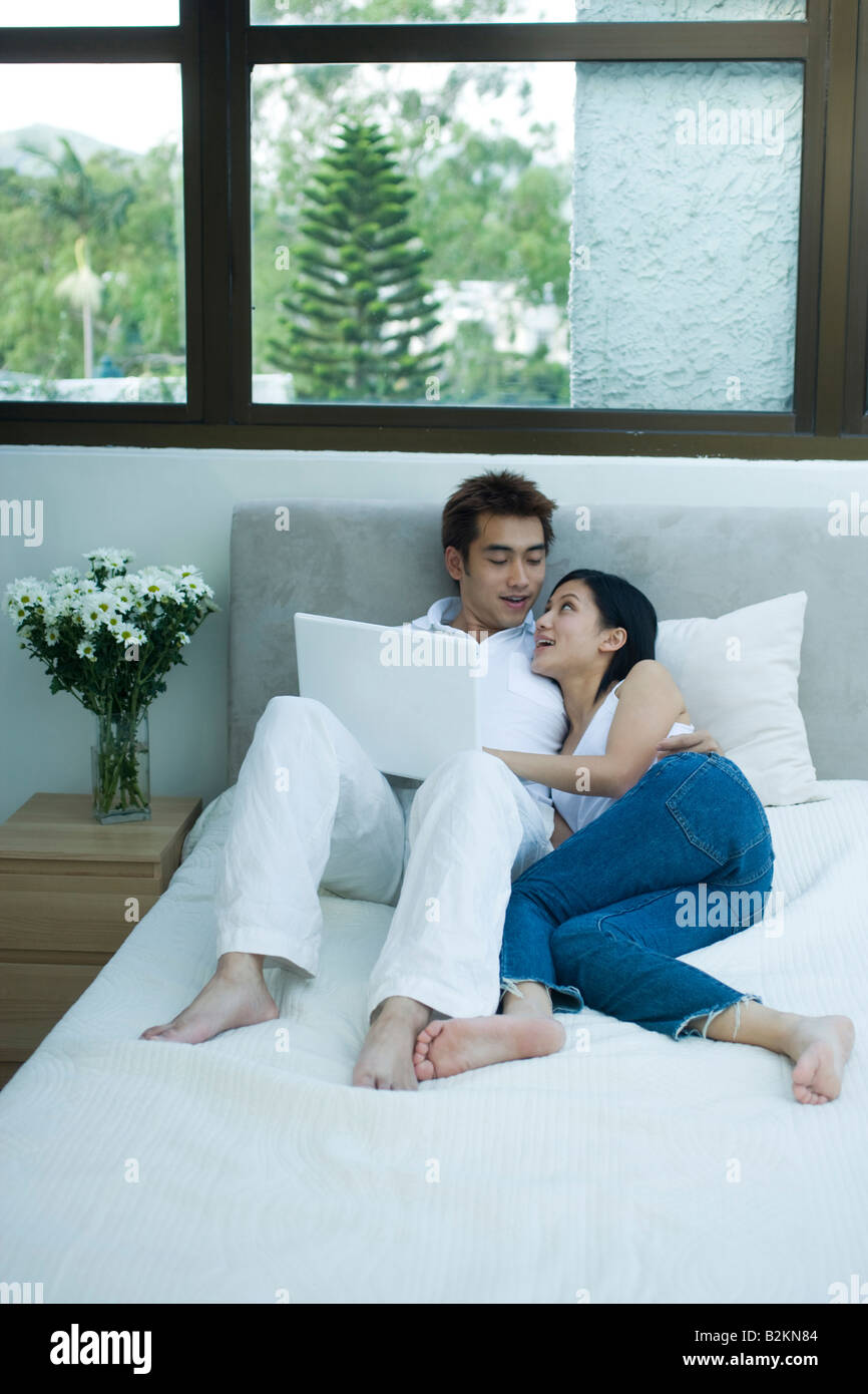 Couple reclining on the bed Stock Photo Alamy