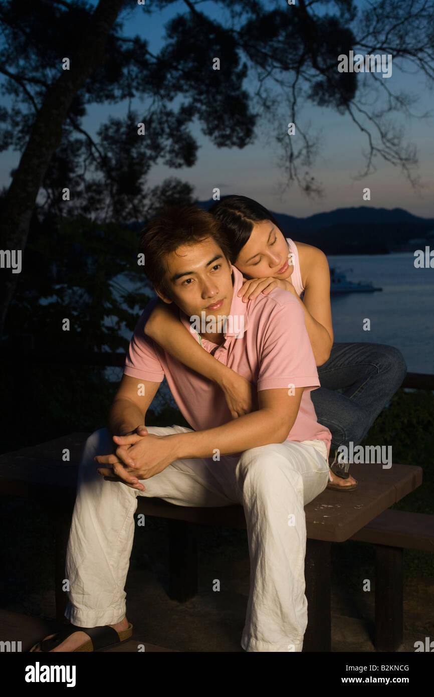 Mid adult woman embracing a young man from behind Stock Photo - Alamy