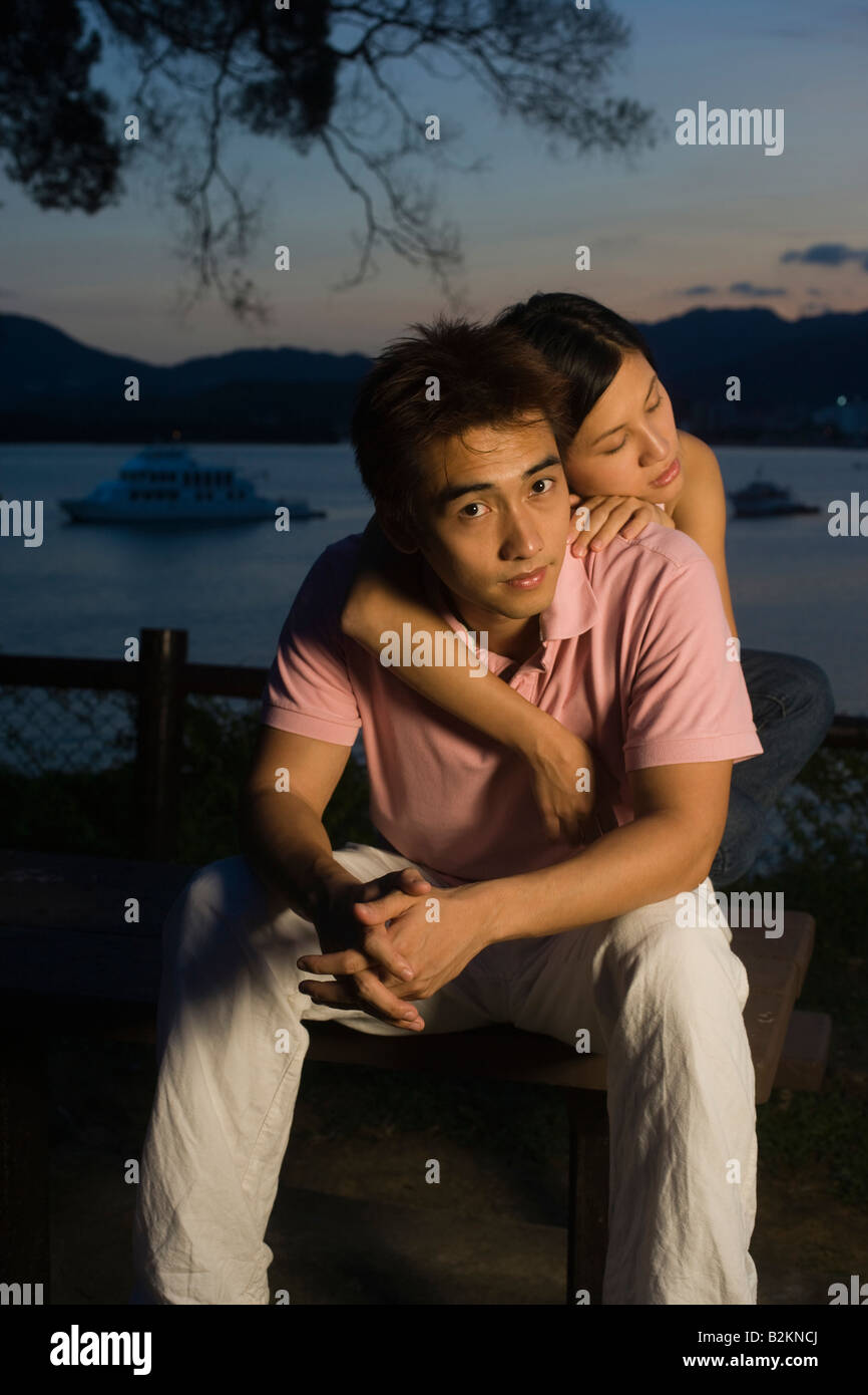Mid adult woman embracing a young man from behind Stock Photo - Alamy